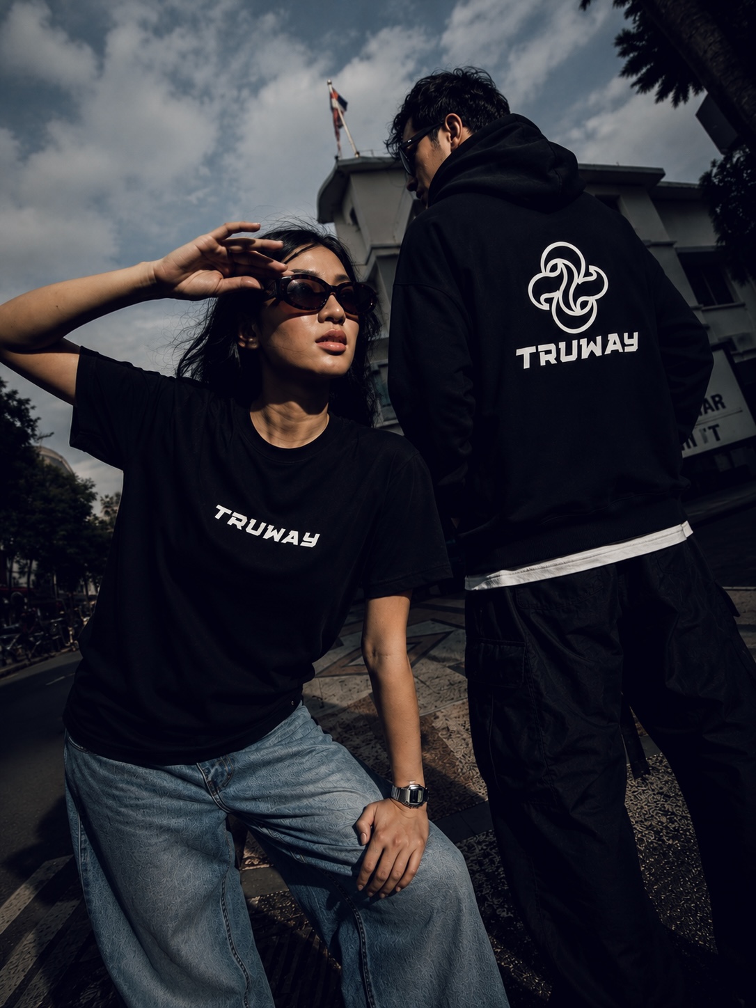 A pair on the street in the TRUWAY tee and hoodie