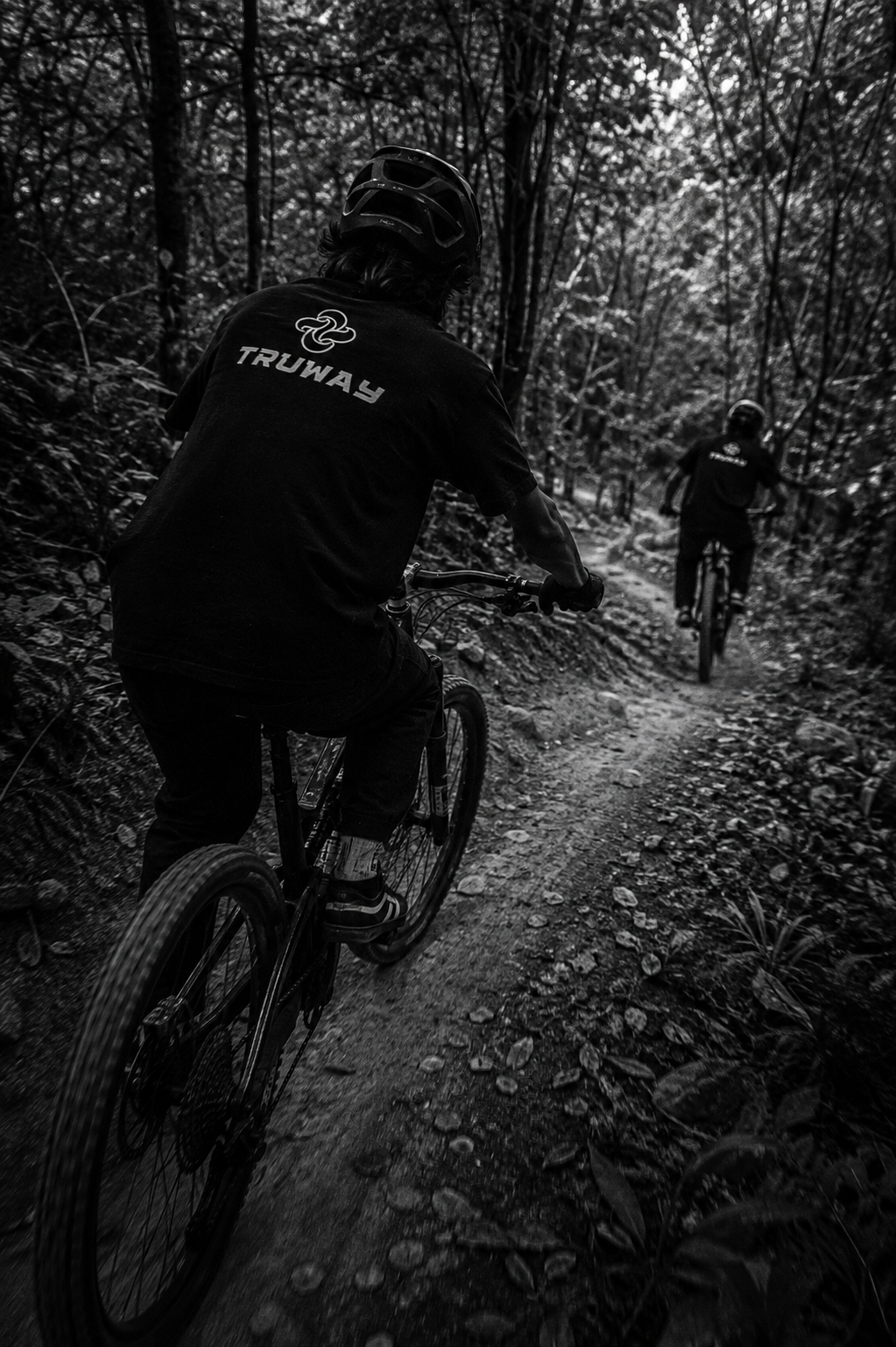 TRUWAY riders mountain biking through the forest